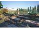 Outdoor picnic area featuring picnic tables, grills, and a view of the tennis courts at 4621 Gulf Of Mexico Dr # 2F, Longboat Key, FL 34228
