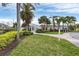 Beautiful clubhouse exterior with lush landscaping, brick pathway, and several palm trees at 4802 51St W St # 1711, Bradenton, FL 34210