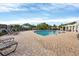 Resort-style pool area with ample lounge chairs, brick patio, and beautiful landscaping at 4802 51St W St # 1711, Bradenton, FL 34210