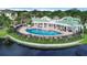 Aerial view of the community pool, surrounded by a brick patio, pool furniture and landscaping at 4802 51St W St # 1711, Bradenton, FL 34210
