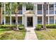 Close up shot of a condominium building entrance framed by palm trees and manicured shrubbery at 4802 51St W St # 1711, Bradenton, FL 34210