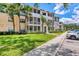 Beautiful condo building with well-maintained landscaping, beige walls, and white balconies at 4802 51St W St # 1711, Bradenton, FL 34210