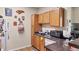 A cozy kitchen featuring wooden cabinets, a sink, and essential appliances at 4802 51St W St # 1711, Bradenton, FL 34210
