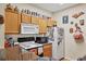 Cozy kitchen with laminate wood flooring, wooden cabinets, white appliances, and dark granite countertops at 4802 51St W St # 1711, Bradenton, FL 34210