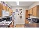 Functional kitchen features laminate wood flooring, wooden cabinets, and white appliances at 4802 51St W St # 1711, Bradenton, FL 34210