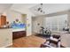 Bright living room with vaulted ceilings, ceiling fans, laminate wood flooring, and leather furniture at 4802 51St W St # 1711, Bradenton, FL 34210