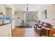 Bright living room featuring laminate wood flooring, a large window, and comfortable leather seating at 4802 51St W St # 1711, Bradenton, FL 34210
