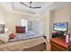 Inviting bedroom featuring a tray ceiling, natural light, and warm furnishings at 4802 51St W St # 1711, Bradenton, FL 34210