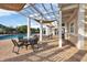 Inviting poolside patio with comfortable seating under a shaded pergola, ideal for relaxation at 4802 51St W St # 1711, Bradenton, FL 34210