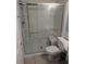 Bathroom with a glass shower, tiled floor, and neutral fixtures at 4833 Dogwood St, New Port Richey, FL 34653