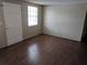 Clean bedroom with wood laminate flooring, natural light, and neutral color palette at 4833 Dogwood St, New Port Richey, FL 34653