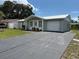 Charming single-story home with a well-maintained lawn and a paved driveway leading to an attached garage at 4833 Dogwood St, New Port Richey, FL 34653