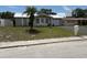 Lovely single-story home with a manicured lawn, palm tree, and a neatly paved driveway leading to the garage at 4833 Dogwood St, New Port Richey, FL 34653