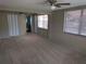 Spacious main bedroom featuring carpeted floors, ceiling fan, and en-suite bathroom at 4833 Dogwood St, New Port Richey, FL 34653