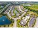Aerial view of a community with a lake and pool with lounge seating at 5007 Sunnyside Ln, Bradenton, FL 34211