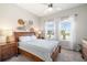 Cozy bedroom boasts ample natural light, a ceiling fan, and stylish wall decor for a comfortable and inviting ambiance at 5007 Sunnyside Ln, Bradenton, FL 34211