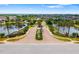 Community entrance with lush landscaping and serene ponds in a neighborhood at 5007 Sunnyside Ln, Bradenton, FL 34211