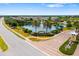 Aerial view of the community entrance, featuring a pond and landscaping at 5007 Sunnyside Ln, Bradenton, FL 34211