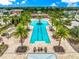 Aerial view of the community pool area featuring lounge chairs and palm trees at 5007 Sunnyside Ln, Bradenton, FL 34211