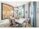 Bright dining room featuring a modern light fixture, seating for six, and a decorative map at 5007 Sunnyside Ln, Bradenton, FL 34211