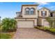 Charming two-story home with a well-manicured lawn and a brick driveway at 5007 Sunnyside Ln, Bradenton, FL 34211