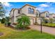 Charming two-story home with a well-manicured lawn and a brick driveway at 5007 Sunnyside Ln, Bradenton, FL 34211