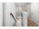Hallway landing with neutral walls and carpets, looking down on a kitchen with light wood floors at 5007 Sunnyside Ln, Bradenton, FL 34211