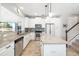 Modern kitchen with granite counters, stainless steel appliances, and a center island at 5007 Sunnyside Ln, Bradenton, FL 34211