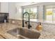 Close-up of kitchen sink, granite countertops, and views into the living room at 5007 Sunnyside Ln, Bradenton, FL 34211