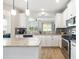 Updated kitchen with granite countertops, an island, and stainless steel appliances at 5007 Sunnyside Ln, Bradenton, FL 34211