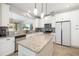 Well-lit kitchen with granite countertops, stainless appliances, white cabinets, and a center island at 5007 Sunnyside Ln, Bradenton, FL 34211