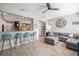 Open-concept living room featuring wood-look tile flooring, a large sofa, and stylish décor at 5007 Sunnyside Ln, Bradenton, FL 34211