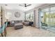 Bright living room with a comfortable sofa, large TV, and sliding glass doors at 5007 Sunnyside Ln, Bradenton, FL 34211
