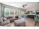 Bright living room with a comfortable sofa, large TV, and sliding glass doors at 5007 Sunnyside Ln, Bradenton, FL 34211