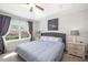Main bedroom featuring a large window, gray headboard, and side tables with lamps at 5007 Sunnyside Ln, Bradenton, FL 34211