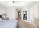 Neutral bedroom featuring a mirror, side table, and a gray bed with decorative pillows at 5007 Sunnyside Ln, Bradenton, FL 34211