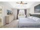 Spacious main bedroom featuring a tray ceiling, carpet, and neutral decor and furniture at 5007 Sunnyside Ln, Bradenton, FL 34211