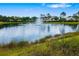 Pond with a water fountain near green grass and homes at 5007 Sunnyside Ln, Bradenton, FL 34211