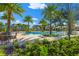 Sparkling community swimming pool with lounge seating, lush landscaping, and plenty of shade at 5007 Sunnyside Ln, Bradenton, FL 34211
