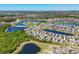 Aerial view of a community with multiple ponds, lush landscaping, and well-maintained homes at 5033 Brickwood Rise Dr, Wimauma, FL 33598