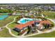 Aerial view of a luxurious community pool and clubhouse with beautifully landscaped grounds and walking paths at 5033 Brickwood Rise Dr, Wimauma, FL 33598