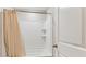The bathroom has a shower and tub combination with a white shower curtain at 5033 Brickwood Rise Dr, Wimauma, FL 33598