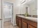 The bathroom features double sinks and a shower and tub combination at 5033 Brickwood Rise Dr, Wimauma, FL 33598