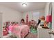 This bedroom is bright with decoratively placed toys at 5033 Brickwood Rise Dr, Wimauma, FL 33598