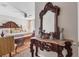 The main bedroom features an antique carved wood vanity and dresser at 5033 Brickwood Rise Dr, Wimauma, FL 33598