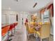 Open concept dining area featuring a glass table and contemporary lighting fixture, and access to kitchen bar at 5033 Brickwood Rise Dr, Wimauma, FL 33598