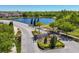 Gated entrance of a meticulously landscaped community with a tranquil pond view at 5033 Brickwood Rise Dr, Wimauma, FL 33598
