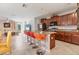 Open concept kitchen and living room featuring a breakfast bar with seating, granite countertops, and stainless appliances at 5033 Brickwood Rise Dr, Wimauma, FL 33598
