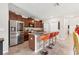 Stylish kitchen featuring stainless steel appliances, granite countertops, dark cabinets, and breakfast bar with seating at 5033 Brickwood Rise Dr, Wimauma, FL 33598