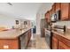 Open kitchen with granite countertops, stainless appliances, and a view into the adjacent living area at 5033 Brickwood Rise Dr, Wimauma, FL 33598
